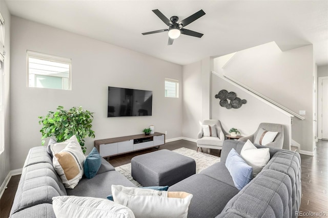 living room with stairs, wood finished floors, baseboards, and ceiling fan