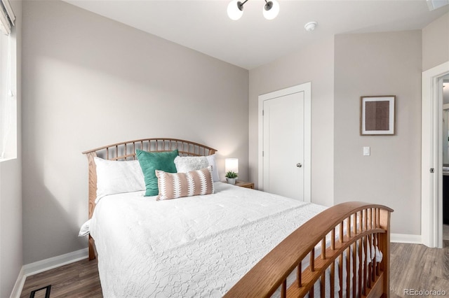 bedroom with baseboards and wood finished floors
