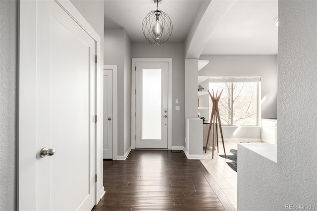 foyer entrance featuring wood finished floors and baseboards