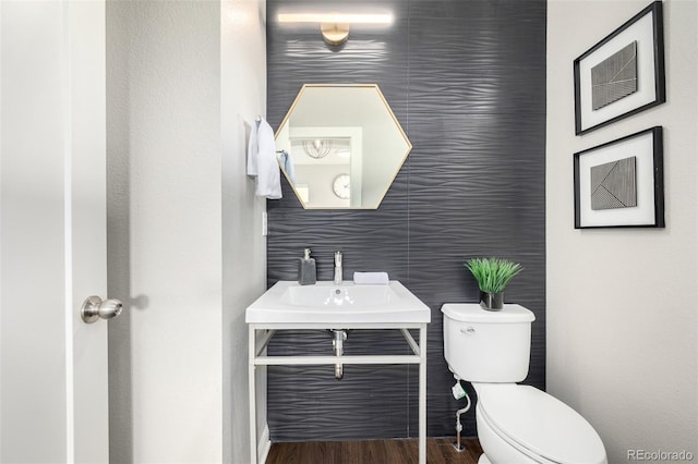 half bath featuring toilet and wood finished floors