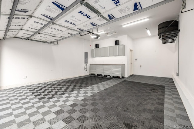 garage with electric panel and a garage door opener