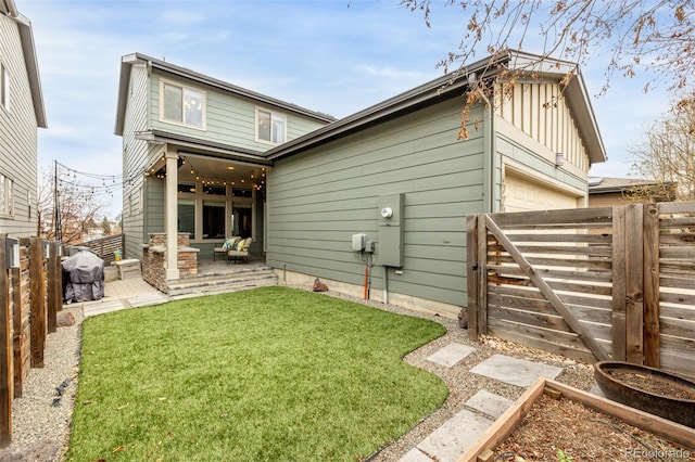 back of house featuring a patio area, a garden, a yard, and fence private yard