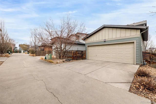 exterior space featuring concrete driveway and fence