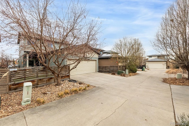 view of front of home featuring fence, a garage, and driveway