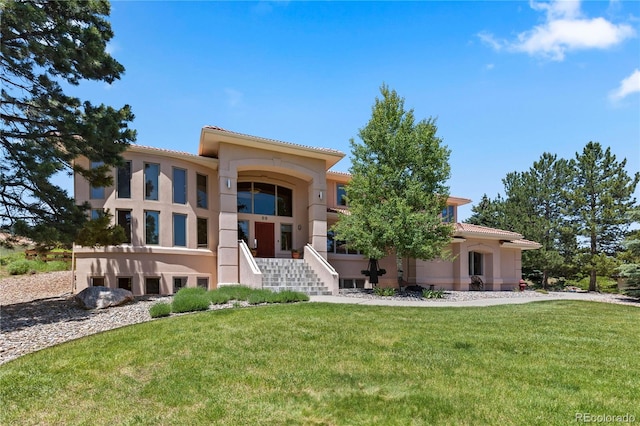 69 N Ranch Rd, Littleton, CO 80127 - mediterranean / spanish-style house featuring stucco siding, a front yard, and a tiled roof