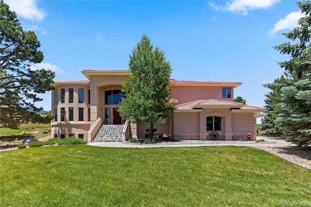 69 N Ranch Rd, Littleton, CO 80127 - rear view of property with a yard, stucco siding, and a tile roof
