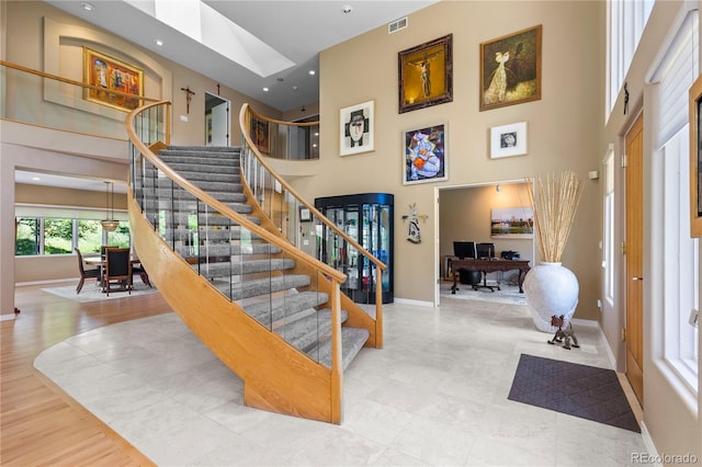 69 N Ranch Rd, Littleton, CO 80127 - stairway with a towering ceiling, baseboards, and recessed lighting