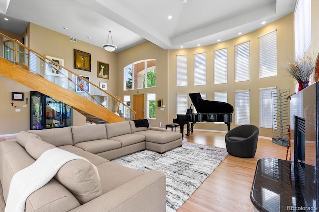 69 N Ranch Rd, Littleton, CO 80127 - living area featuring a towering ceiling, stairway, wood finished floors, recessed lighting, and baseboards