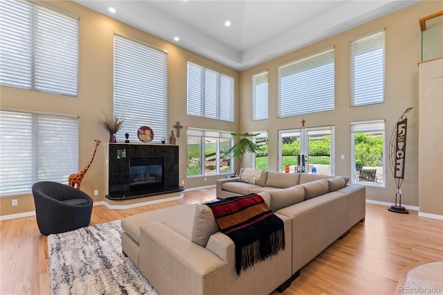 69 N Ranch Rd, Littleton, CO 80127 - living area featuring a high ceiling, light wood finished floors, baseboards, recessed lighting, and a high end fireplace