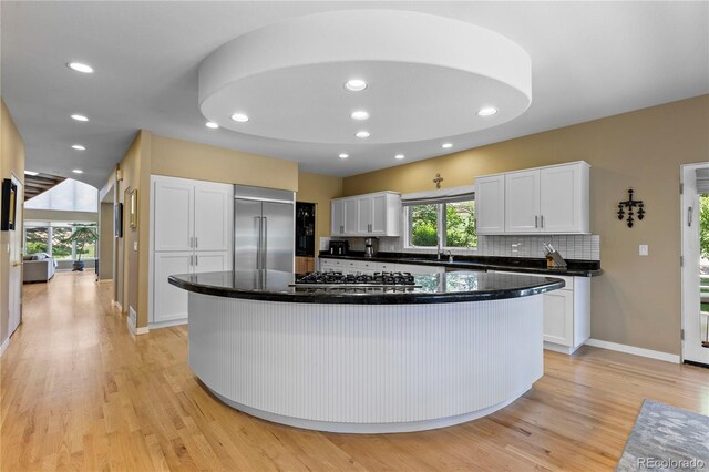 69 N Ranch Rd, Littleton, CO 80127 - kitchen featuring stainless steel appliances, white cabinetry, light wood-type flooring, recessed lighting, and a kitchen island