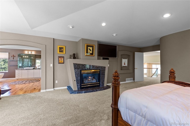 69 N Ranch Rd, Littleton, CO 80127 - carpeted bedroom featuring baseboards, a high end fireplace, arched walkways, and recessed lighting