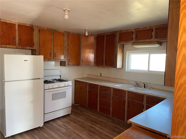 kitchen with sink, dark hardwood / wood-style floors, and white appliances