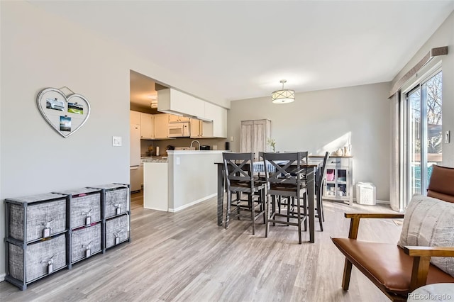 dining space featuring light wood-type flooring