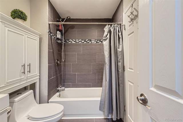 bathroom with shower / tub combo with curtain and toilet