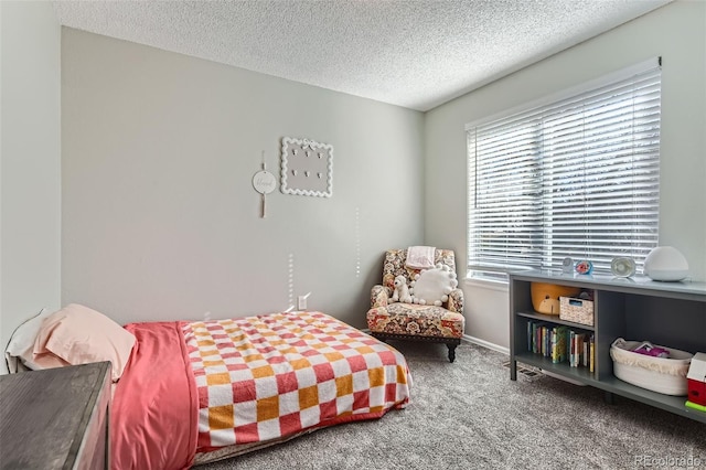 carpeted bedroom featuring a textured ceiling