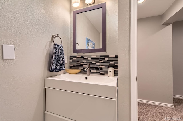 bathroom with tasteful backsplash and vanity