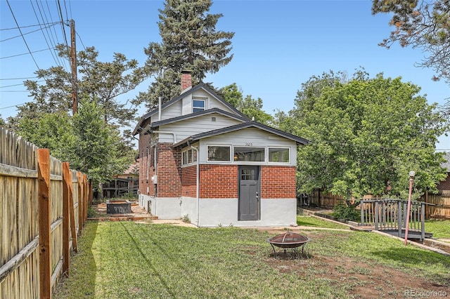 3655 Zenobia St, Denver, CO 80212 - rear view of property featuring a fire pit, brick siding, and a chimney