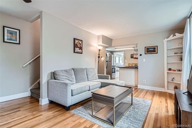 3655 Zenobia St, Denver, CO 80212 - living area with light wood finished floors, baseboards, and stairway