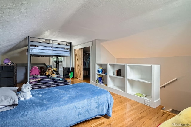 3655 Zenobia St, Denver, CO 80212 - bedroom featuring vaulted ceiling, wood finished floors, a textured ceiling, and a closet