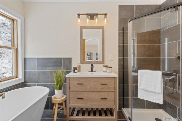 full bath featuring a stall shower, plenty of natural light, tile walls, and a soaking tub