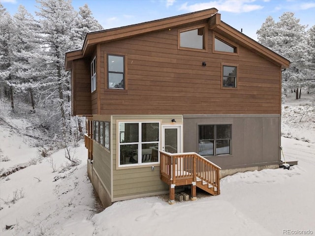 view of snow covered rear of property