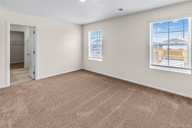 unfurnished bedroom with visible vents, baseboards, and carpet floors