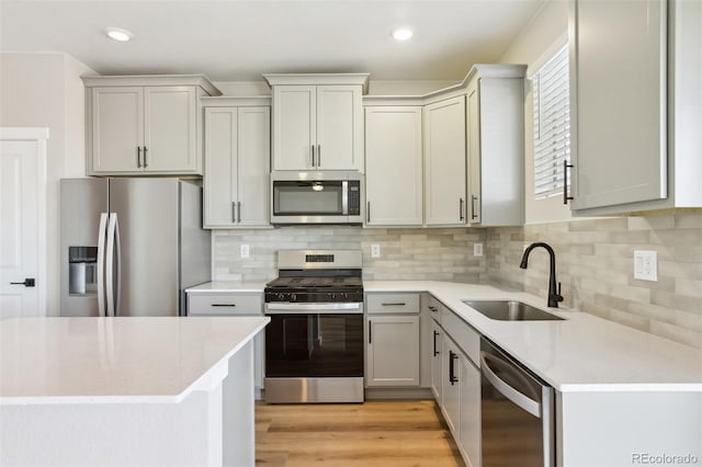17943 E 94th Pl, Commerce City, CO 80022 - kitchen with stainless steel appliances, light countertops, light wood finished floors, decorative backsplash, and recessed lighting