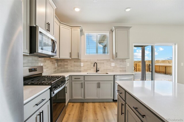17943 E 94th Pl, Commerce City, CO 80022 - kitchen with appliances with stainless steel finishes, light countertops, plenty of natural light, gray cabinets, and recessed lighting