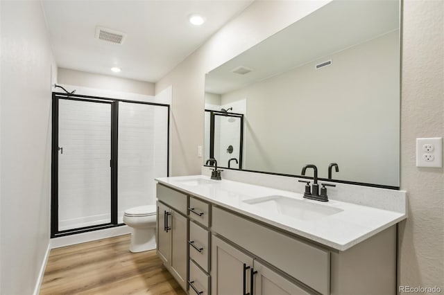 17943 E 94th Pl, Commerce City, CO 80022 - full bathroom with double vanity, a stall shower, and wood finished floors