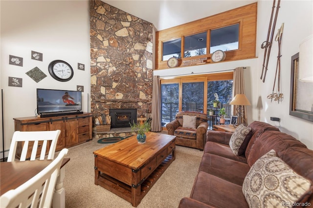 living area featuring high vaulted ceiling, a wood stove, and carpet