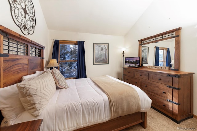 bedroom featuring vaulted ceiling and carpet flooring