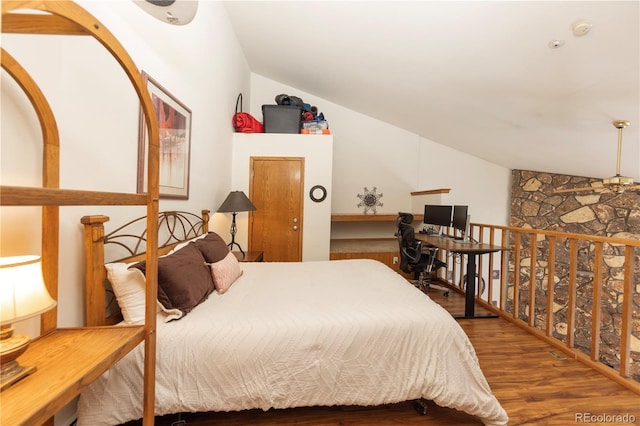 bedroom featuring wood finished floors and vaulted ceiling