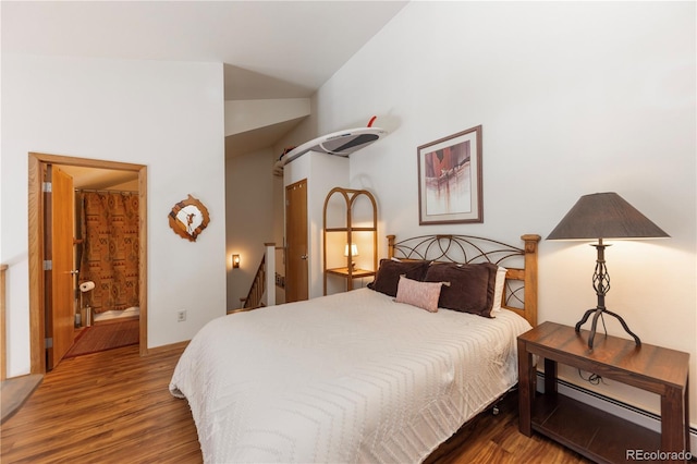 bedroom with a baseboard radiator, lofted ceiling, and wood finished floors