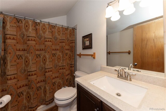 bathroom featuring vanity, a shower with shower curtain, and toilet