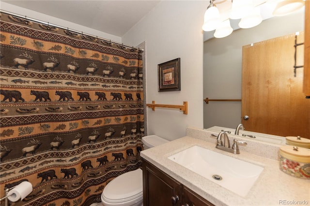 bathroom with vanity, toilet, and a shower with curtain