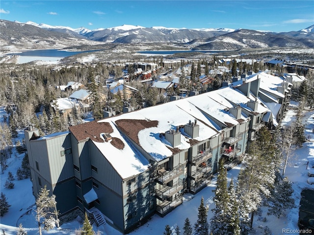 snowy aerial view with a mountain view