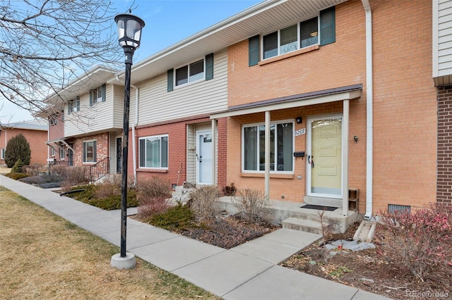 townhome / multi-family property with brick siding