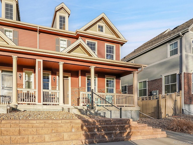 view of front of property with covered porch and brick siding