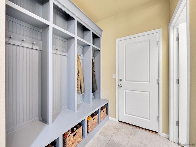 mudroom with baseboards and light tile patterned flooring