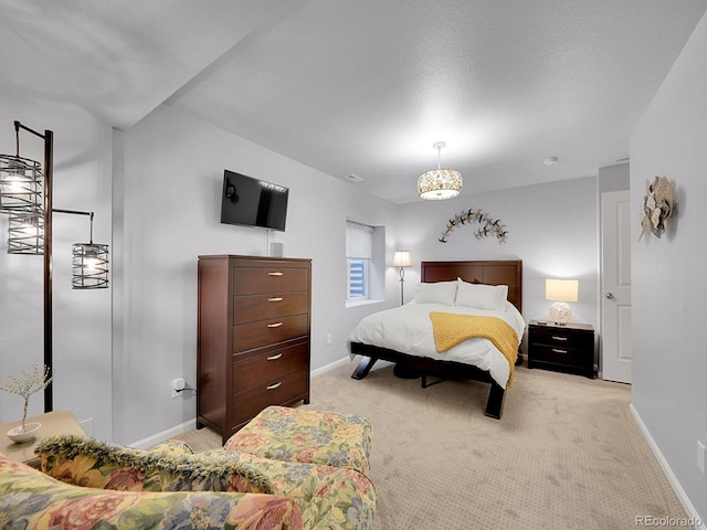 bedroom featuring light carpet and baseboards