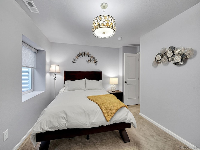 bedroom featuring light carpet, visible vents, and baseboards