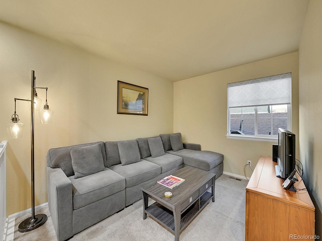 living room featuring light carpet, visible vents, and baseboards