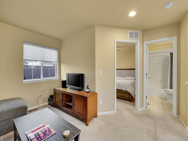 living area with light carpet, recessed lighting, visible vents, and baseboards