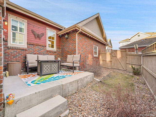 view of patio / terrace featuring a gate, fence, and an outdoor hangout area