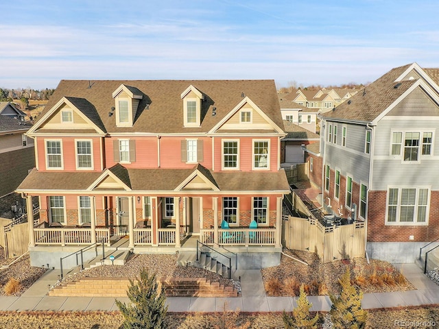 view of front of house with covered porch and fence