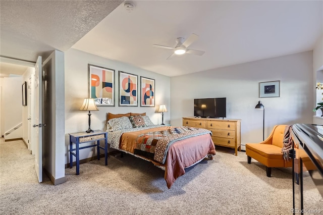 bedroom with carpet, ceiling fan, a textured ceiling, and baseboards