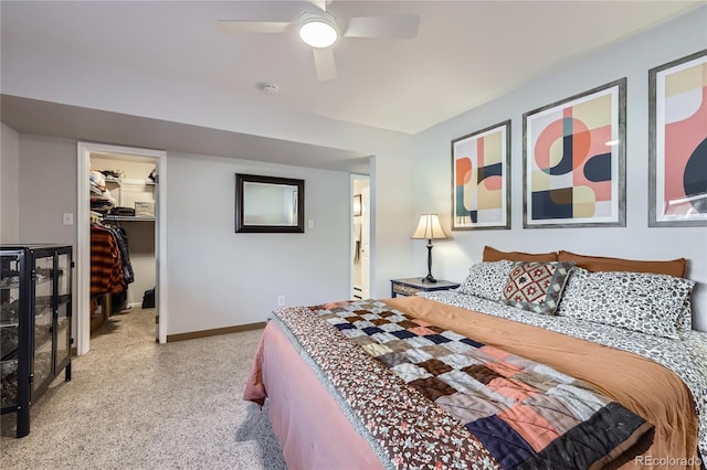 bedroom featuring ceiling fan, a spacious closet, baseboards, and a closet