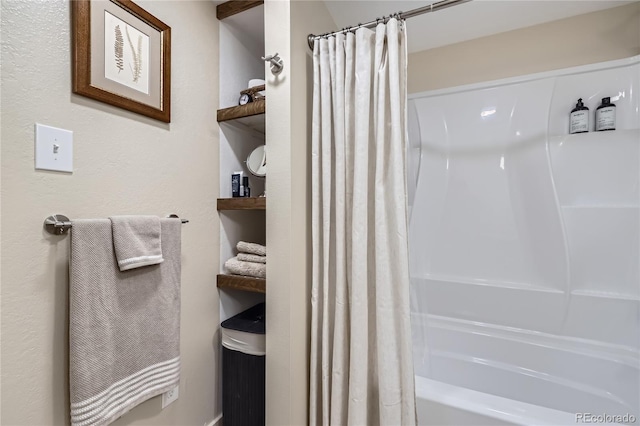 bathroom with shower / bath combo with shower curtain