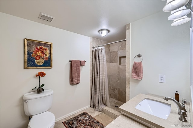 bathroom with visible vents, a sink, a tile shower, and toilet