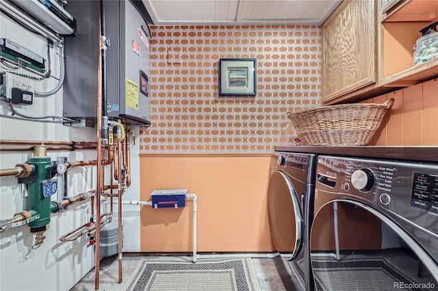 clothes washing area with cabinet space and washer and clothes dryer